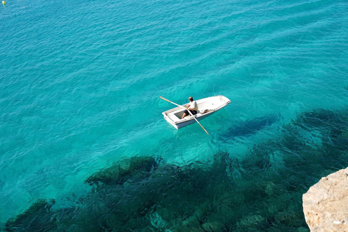 Rowboat on clear turquoise water
