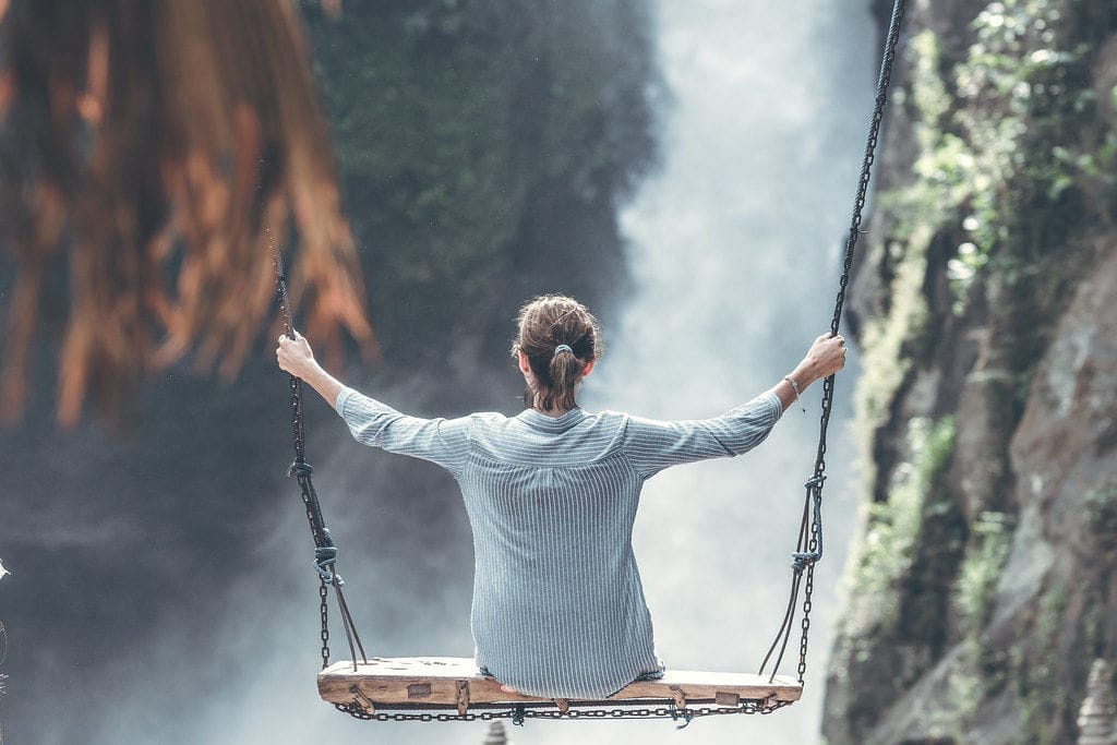 Swing beneath a jungle waterfall